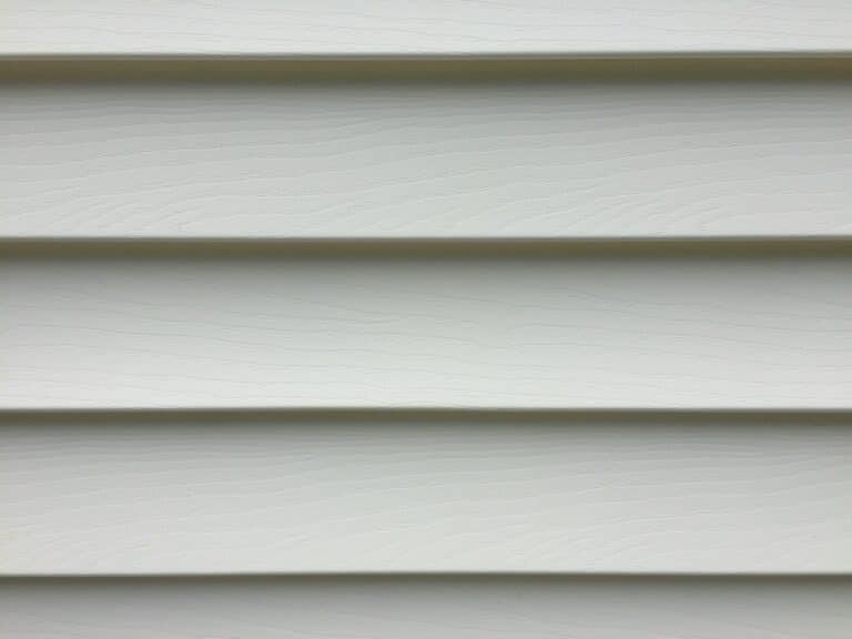 Recently cleaned vinyl siding on a white house